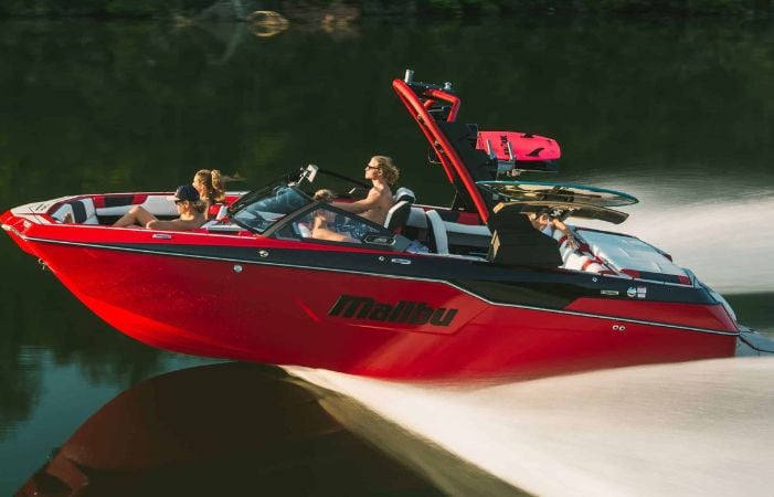 people riding in a wake boat