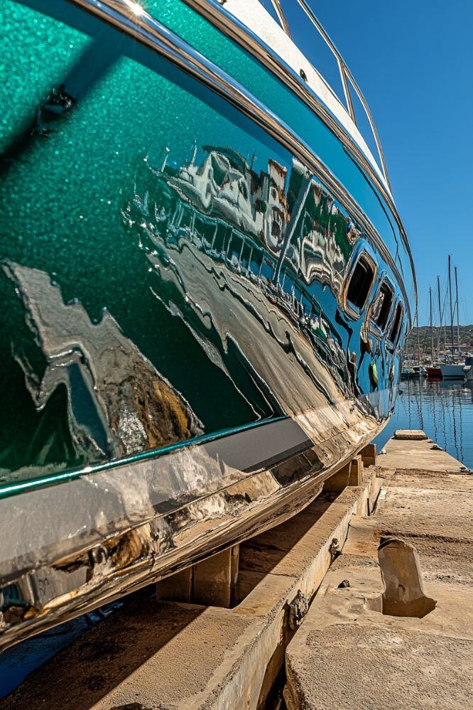 Close-up of a boat's gelcoat reflecting its surroundings after a compounding and polishing service from A1 Marine Care..