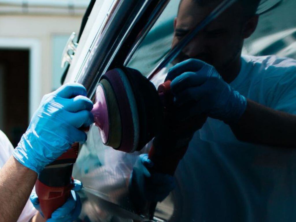 Technician performing wet sanding as part of a professional gelcoat restoration service to remove deep imperfections from a boat’s surface.